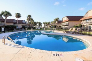 A swimming pool with a 8 ft no diving sign, surrounded by lounge chairs and palm trees. - OCEANFRONT Midisle Prvt Pool 3New Baths,Kitchen,Floors, AC,Total Renovation!     (Fripp Island)