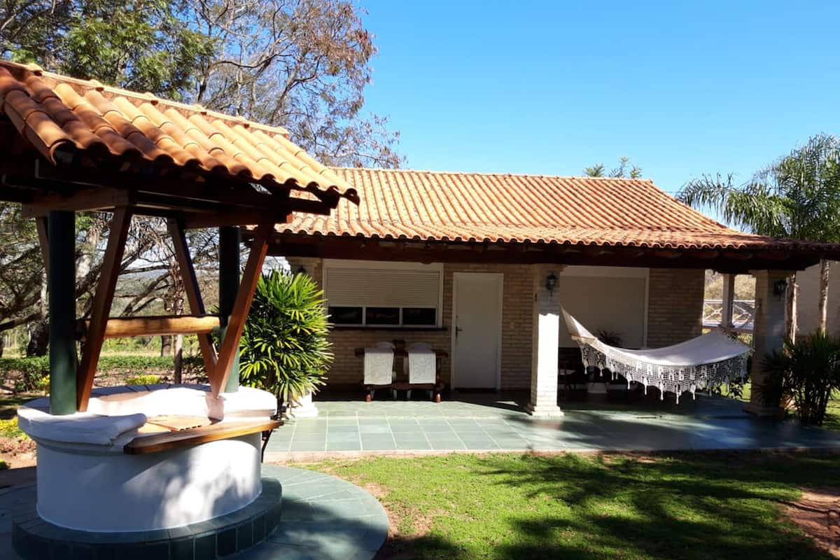 A house with a tiled roof, a covered patio, and a hammock.