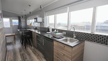 Deluxe Apartment, 1 Bedroom | Private kitchen | Fridge, microwave, stovetop, coffee/tea maker
