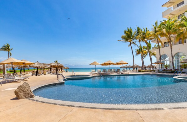 2 outdoor pools, pool umbrellas, pool loungers - Villa del Palmar Beach Resort and Spa - All Inclusive (Puerto Vallarta)