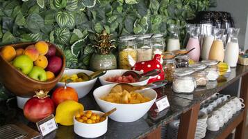 A buffet with various fruits and condiments.