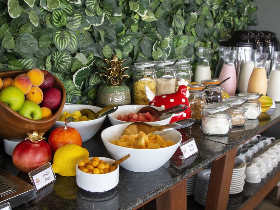 A buffet with various fruits and condiments.