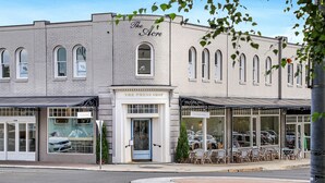 A historic building with a storefront labeled "The Press Shop" and a visible entrance. - Amber Cottage - country cottage (Bowral)
