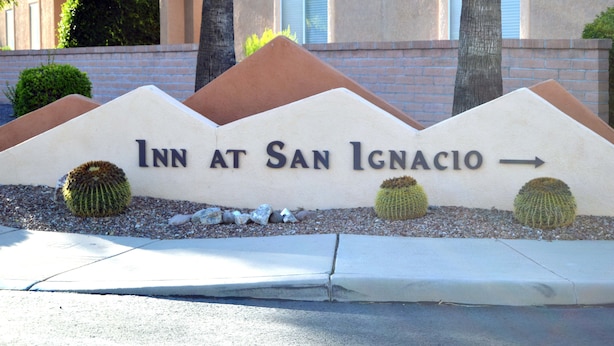 A sign for the Inn at San Ignacio with directional arrows and cacti landscaping. - Luxury Studio Apartment Located in a Popular High Desert Resort (Green Valley)