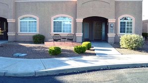 A building with a symmetrical facade, arched windows, and a central entrance. - Luxury Studio Apartment Located in a Popular High Desert Resort (Green Valley)