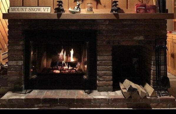 A fireplace with a sign above it reading "MOUNT SNOW, VT".