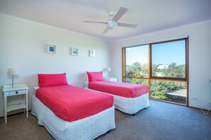 A bedroom with two beds, white nightstands, and a ceiling fan. - BAYSIDE BLISS | BEACH & SPECTACULAR VIEWS | SLEEPS UP TO 12 | RYE (Rye)