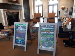 Relax in the lounge with comfortable seating and tropical artwork.