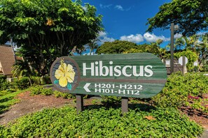 A sign for Hibiscus with directional arrows and route numbers H201-H212 and H101-H112.