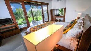A bedroom with a bed, a TV, a desk, and a view of the outdoors. - Bali style villa 5 minutes from ubud center! (Ubud)