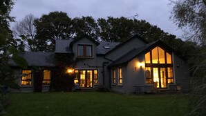 A two-story house with large windows and a well-maintained lawn. - The Vandees (Craigavon)