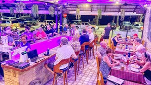 A restaurant with outdoor seating, a counter, and a variety of patrons dining. - Happy Vikings - Beachfront (Pattaya)