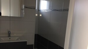 A bathroom with a sink, mirror, toilet, and a trash bin. - Studio, two people, Haut-Doubs, Plateau du Pays Horloger between Maîche and Mor (Le Russey)