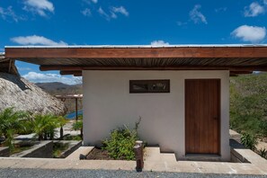 A small, single-story building with a wooden door and a framed picture above it. - Exclusive Two Story Ocean View Home/private Pool ++privacy - Families Welcome! (San Juan del Sur)