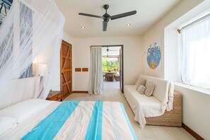 A bedroom with a bed, a sofa, a ceiling fan, and a window with curtains. - Exclusive Two Story Ocean View Home/private Pool ++privacy - Families Welcome! (San Juan del Sur)