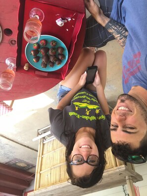 A dining table with a plate of strawberries and two glasses of a clear liquid, possibly water or juice. -  CLEAN, COZY LAKE CABIN COMFORT... (Clifton)