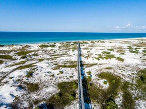 A long, straight railway track extending into the distance across a flat, open landscape with sparse vegetation and a clear blue sky above. - Prominence townhome on 30A across fr the Big Chill, heated pool & cruiser bikes! (Santa Rosa Beach)