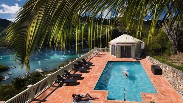 A pool area with a view of boats on the water, a gazebo, and lounge chairs. - Million Dollar Panoramic Views! Huge Decks and  Pool! (Coral Bay)