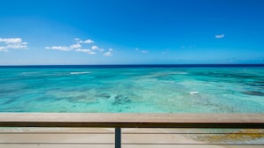 A clear view of the ocean from a wooden deck. - LUXURY PENTHOUSE!! Courtesy SUV Included, PaddleBoards, Bikes, Chairs & More! (Cockburn Town)