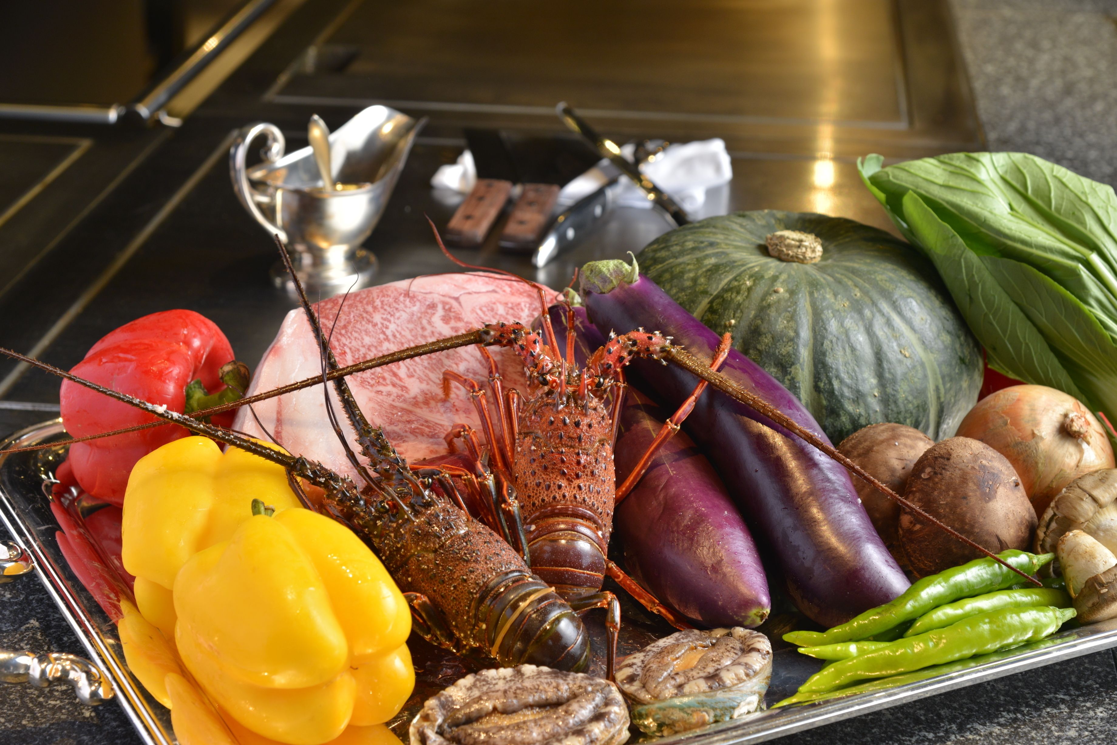 A variety of seafood and vegetables on a tray.