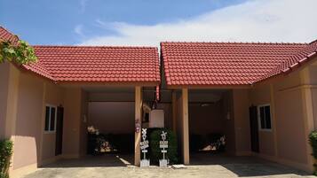 A building with a red-tiled roof and a covered entrance area.