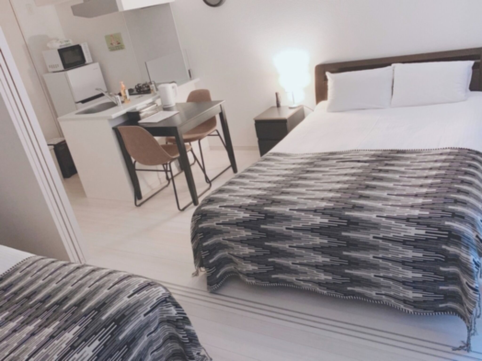 Una habitación de hotel con una cama, un escritorio y una silla.