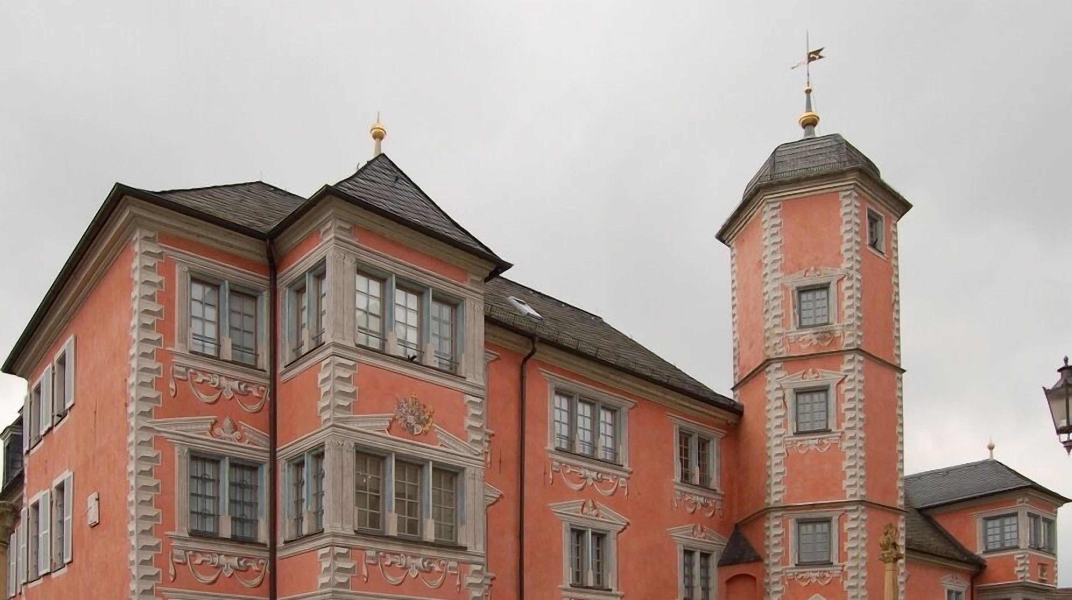 A historic building with a prominent tower and multiple windows.