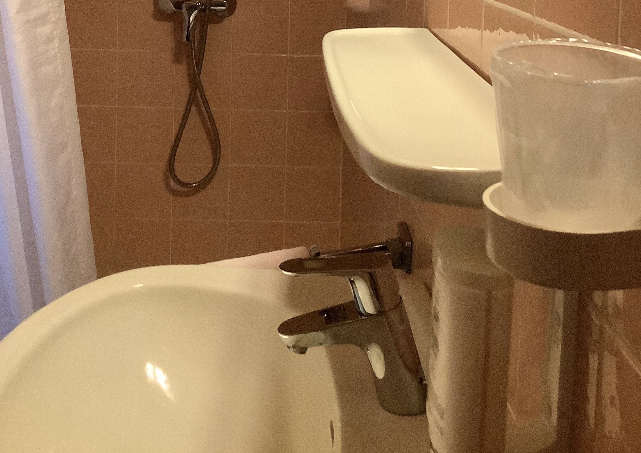 A bathroom with a bathtub, a sink, and a shower.