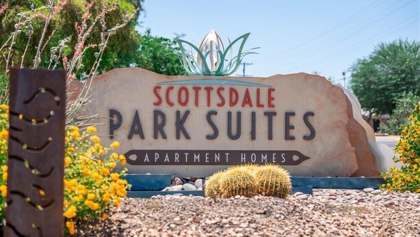 A sign for Scottsdale Park Suites, an apartment home.