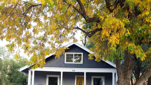 A two-story house with a gray exterior, white trim, and a yellow front door. - Quiet, Convenient Location w/ Great Amenities-Full Kitchen-Washer/Dryer-5g Wifi  (Hyrum)