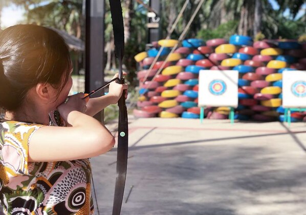 A person aiming an arrow at a target. - Tadom Hill Resorts (Banting)