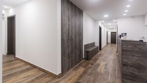A modern hallway with wooden flooring and a reception desk. - Apinelo Tower Rooms (Split)