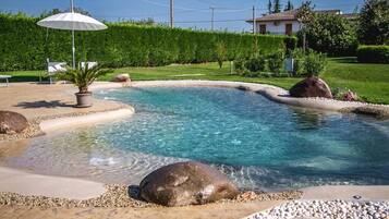 Seasonal outdoor pool, open 9:00 AM to 8:00 PM, pool umbrellas