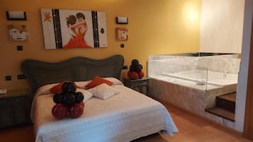 Una habitación de hotel con una cama grande, una bañera y obras de arte en las paredes.