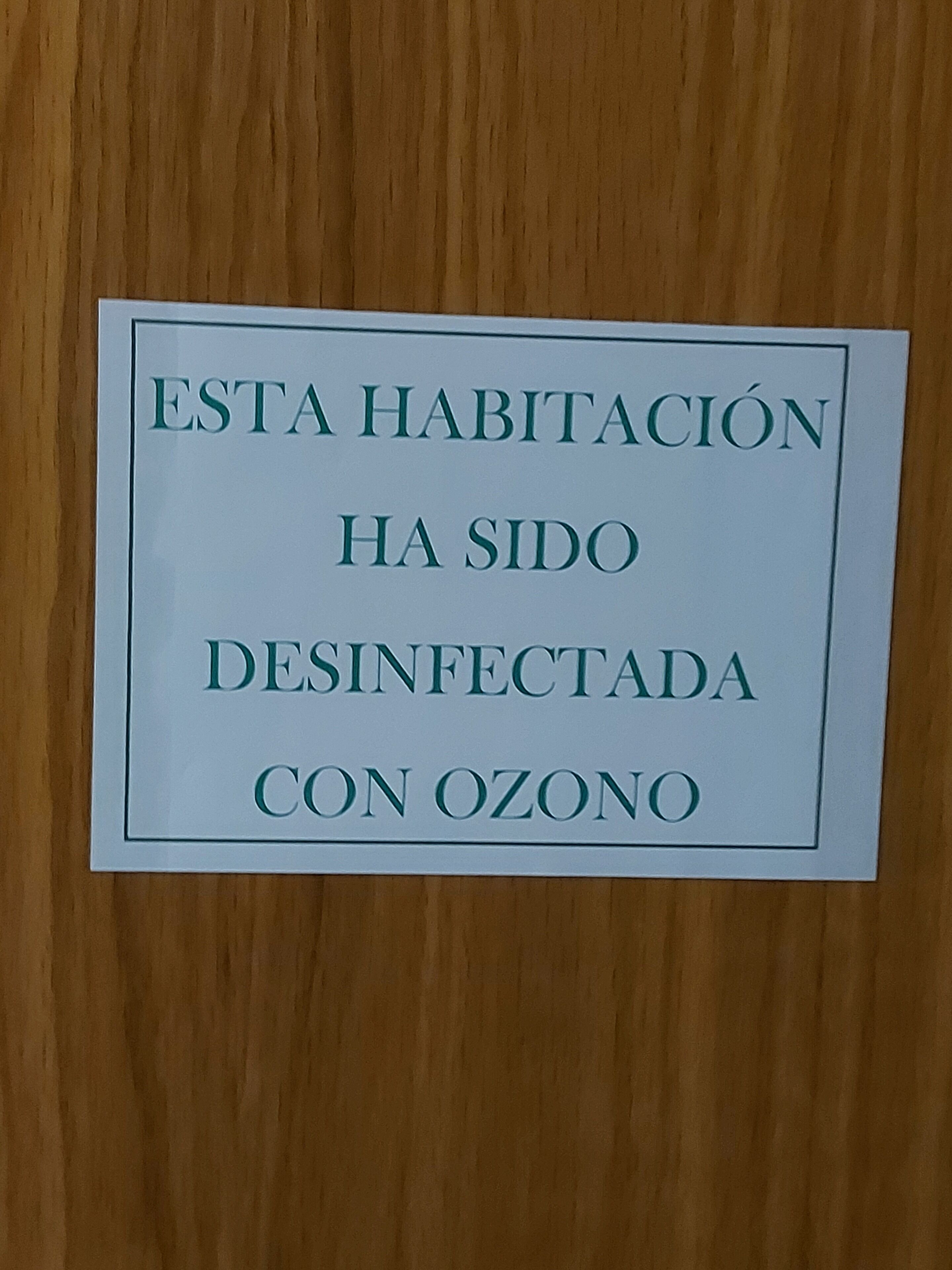 A sign stating the room has been disinfected with ozone.