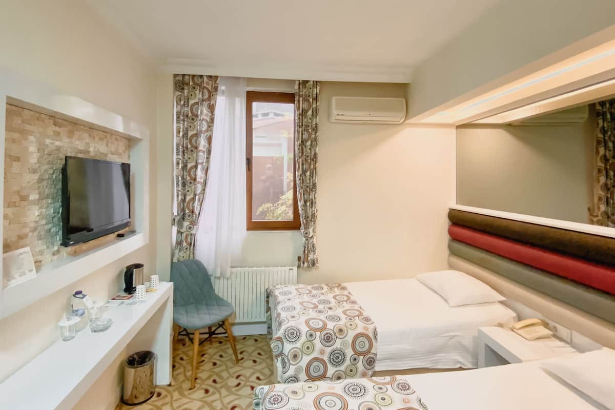 standard room with garden view | premium bedding, minibar, desk, laptop workspace