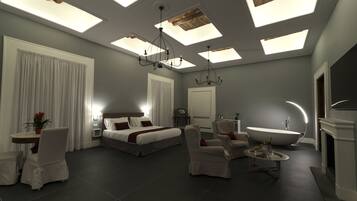 Una moderna camera d'albergo con un ampio letto, un'area salotto con tavolo e sedie, una vasca da bagno e lucernari.