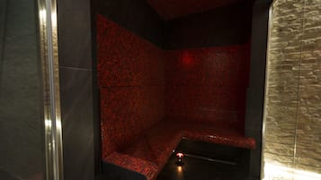 Experience the contemporary bathroom's unique mosaic tile design and glass shower enclosure.