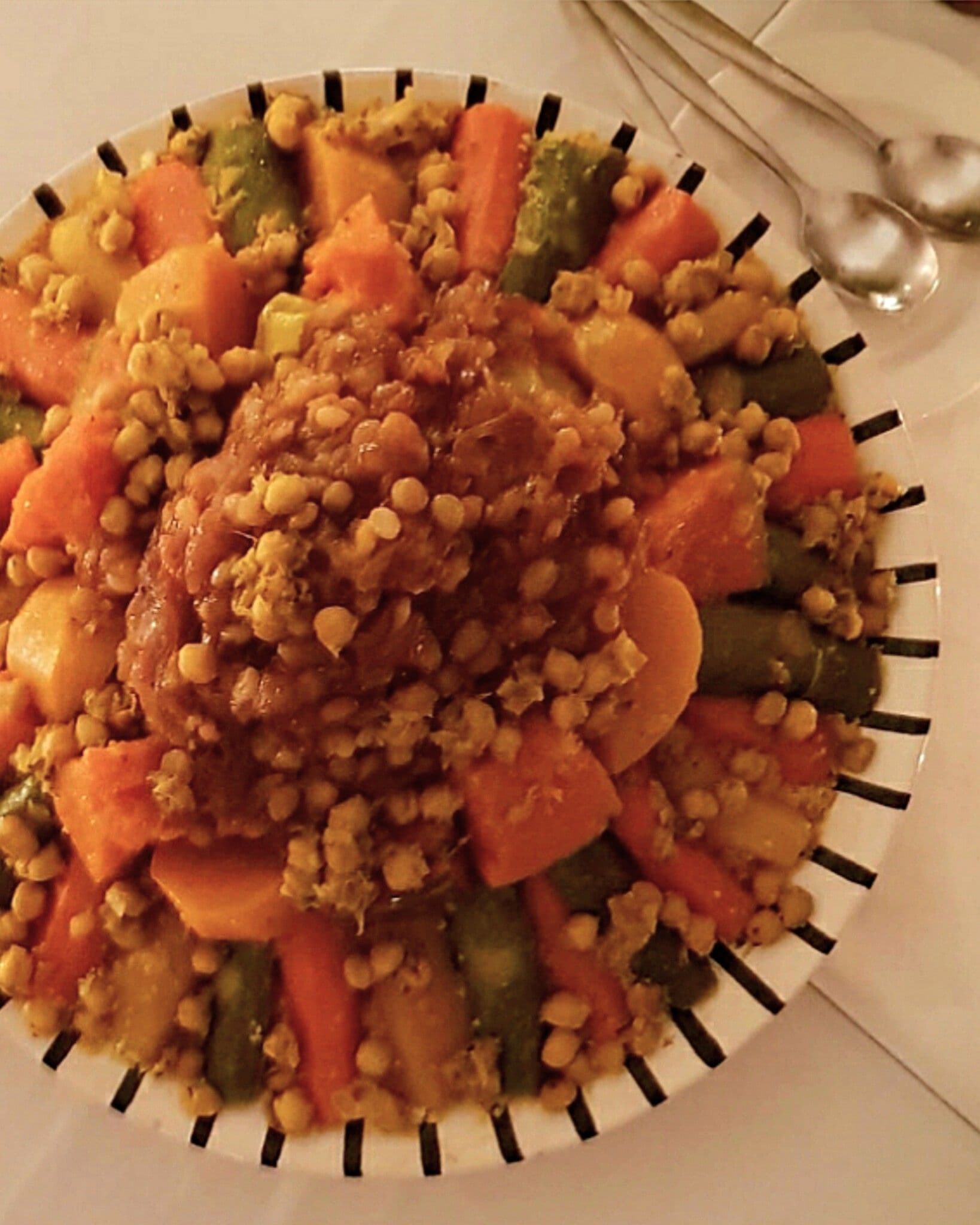 A plate of food with a variety of vegetables and grains.