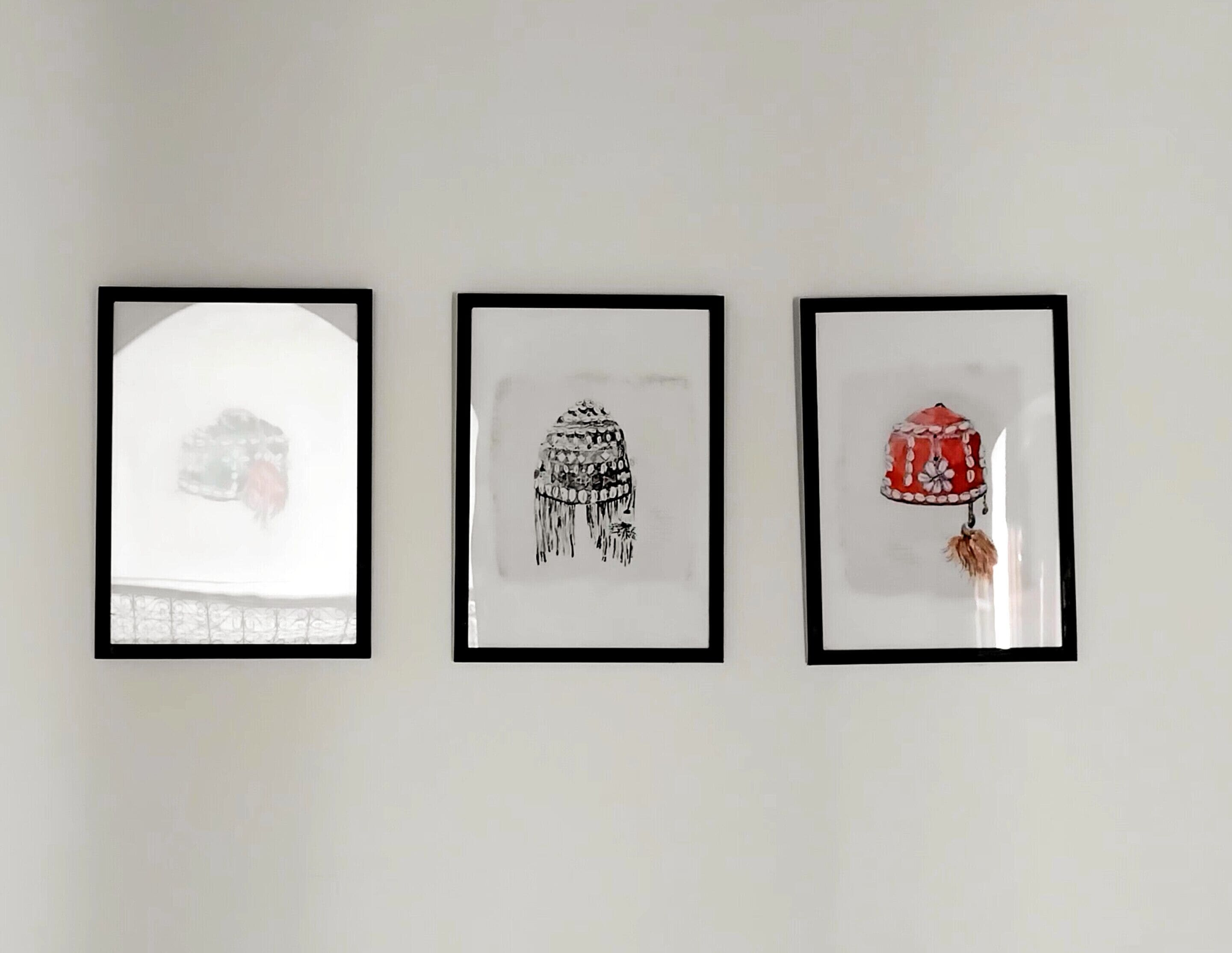 Three framed artworks on a wall.