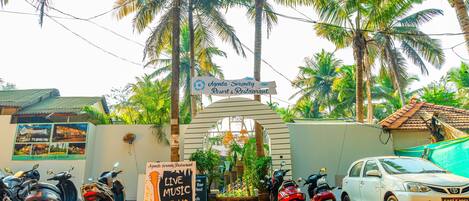 A signboard for Agada Serenity Resort & Restaurant with a live music event announcement.