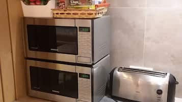 Full-size fridge, microwave, cookware/dishes/utensils