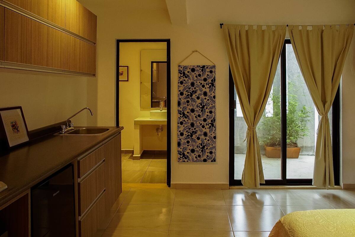 Un baño moderno con lavamanos, espejo y armarios de madera.