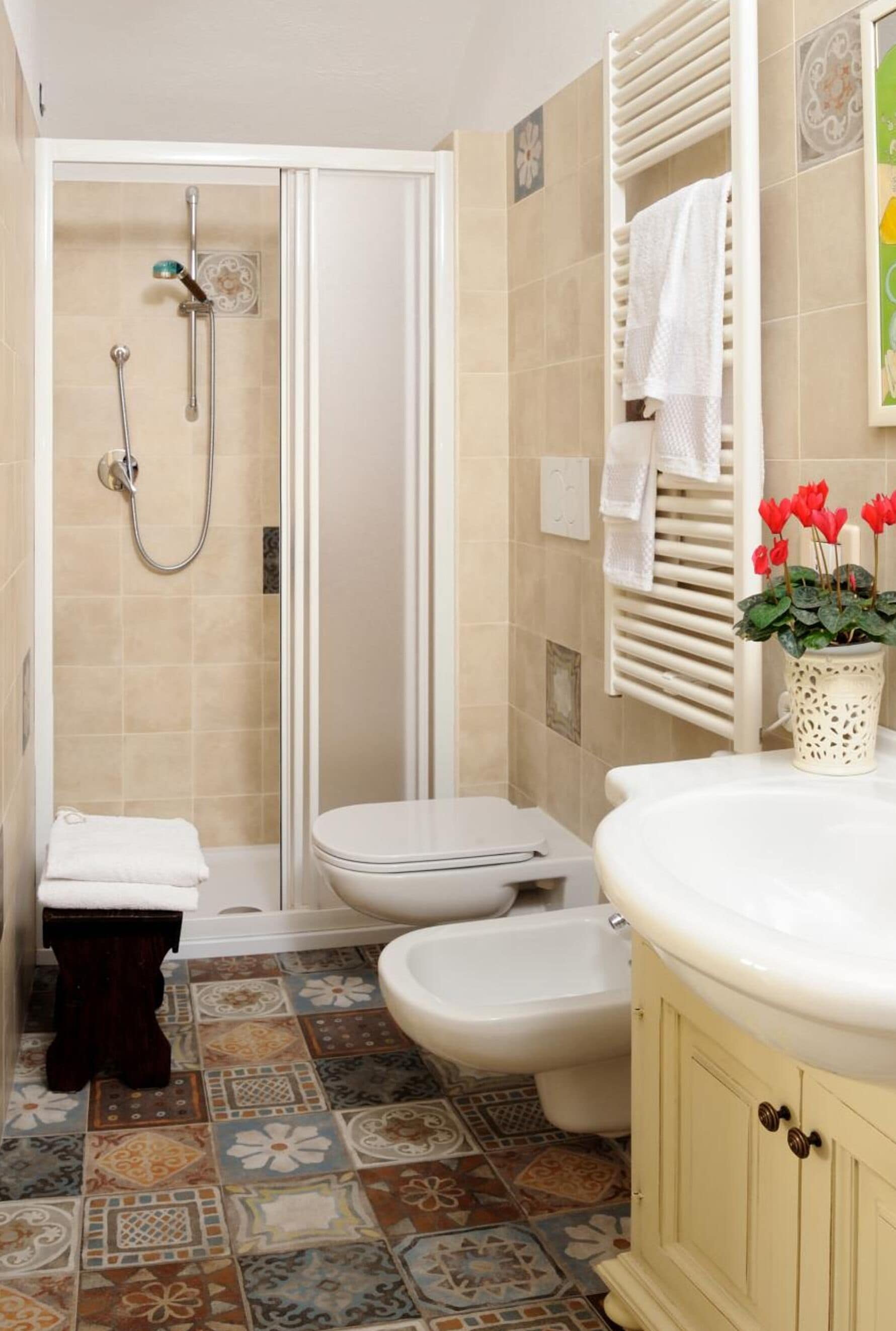 A bathroom with a shower, toilet, and sink.