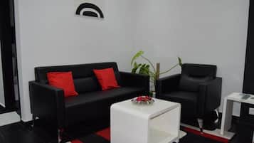Junior Suite, 1 King Bed | Living area | 42-inch TV with satellite channels