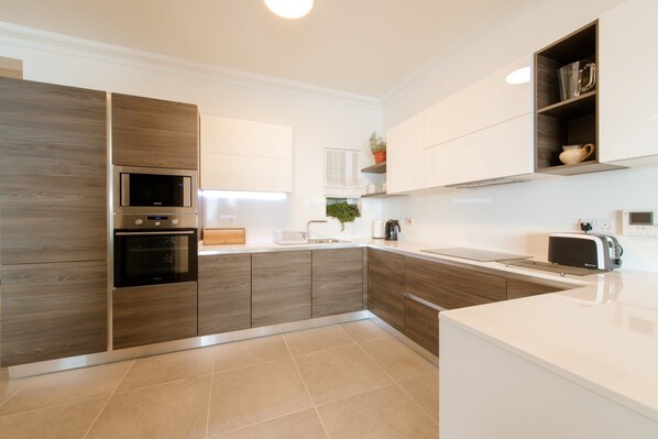 Full-size fridge, oven, dishwasher, cookware/dishes/utensils