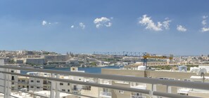 A cityscape with a clear sky, buildings, and a crane. - Luxury Apartment inc Pool & Views (Sliema)