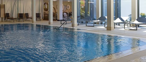 Indoor pool, open 7:00 AM to 10:00 PM, pool loungers