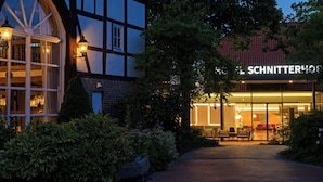 A traditional half-timbered building with a visible sign for 'SCHNITTERHOLZ'. - Hotel Schnitterhof (Bad Sassendorf)
