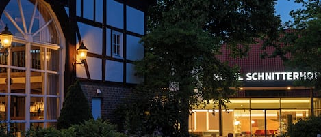 A traditional half-timbered building with a visible sign for 'SCHNITTERHOLZ'.